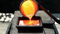Pouring molten copper metal in ingot mold by Tito4re.png